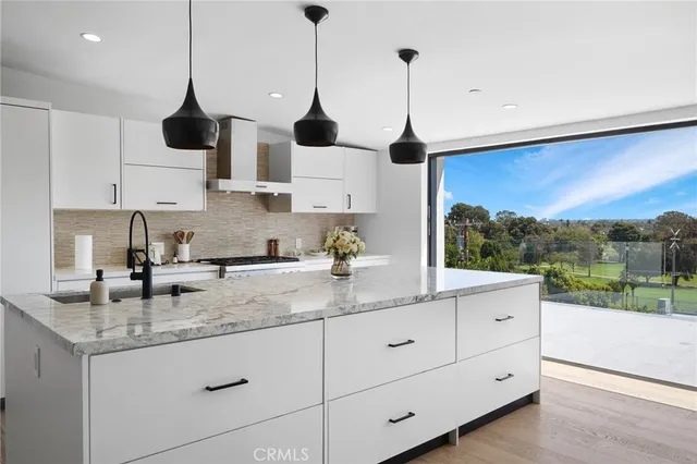 a kitchen with granite countertop white cabinets and white appliances
