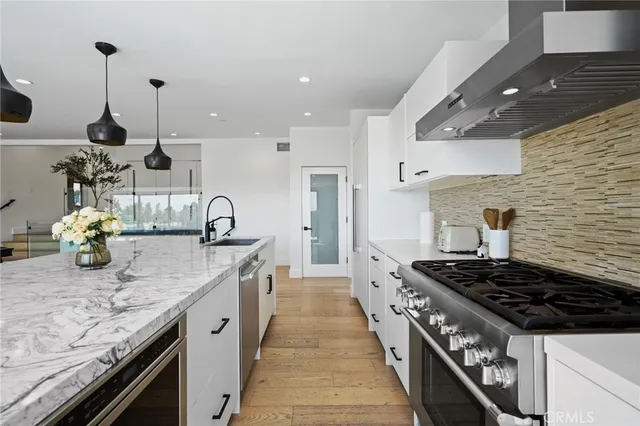 a kitchen with granite countertop a stove and a sink