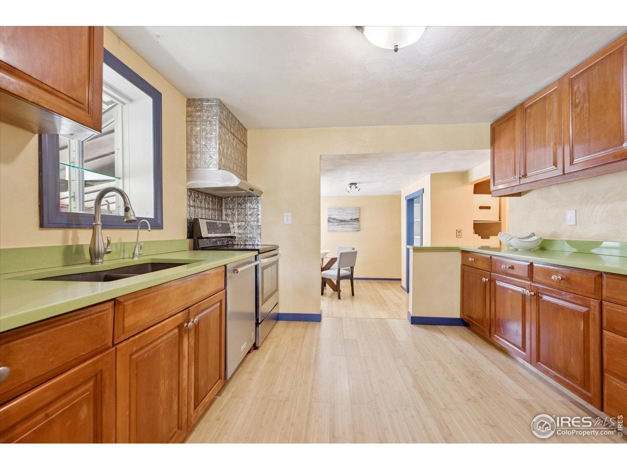 1351 Marshall Road Boulder, CO 80305 - Photo 14 of 46 a kitchen with stainless steel appliances granite countertop wooden cabinets a sink a stove a dining table and chairs