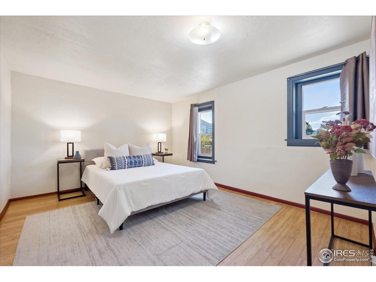 1351 Marshall Road Boulder, CO 80305 - Photo 19 of 46 a bedroom with a bed table and chair