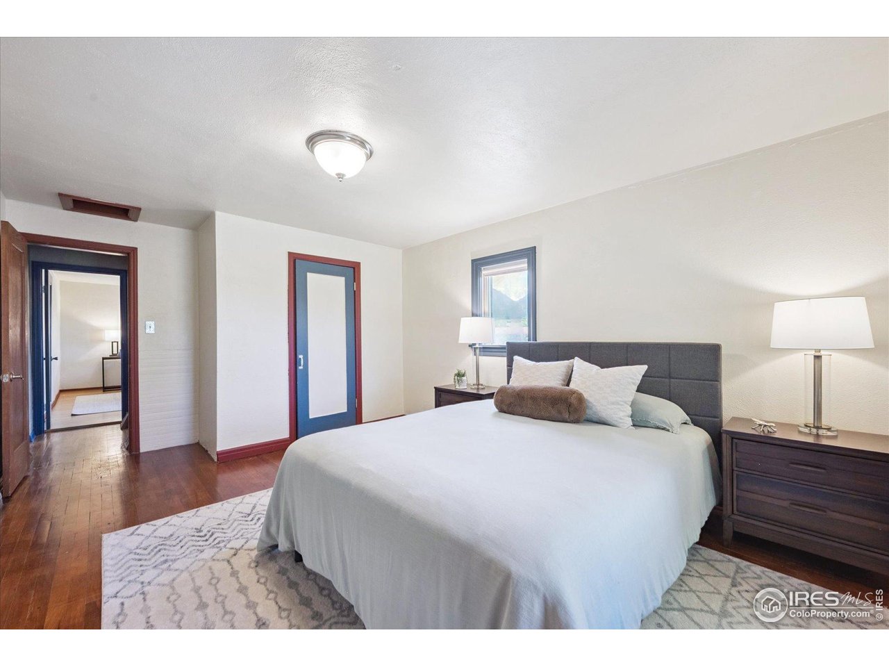 1351 Marshall Road Boulder, CO 80305 - Photo 21 of 46 a bedroom with a bed and wooden floor