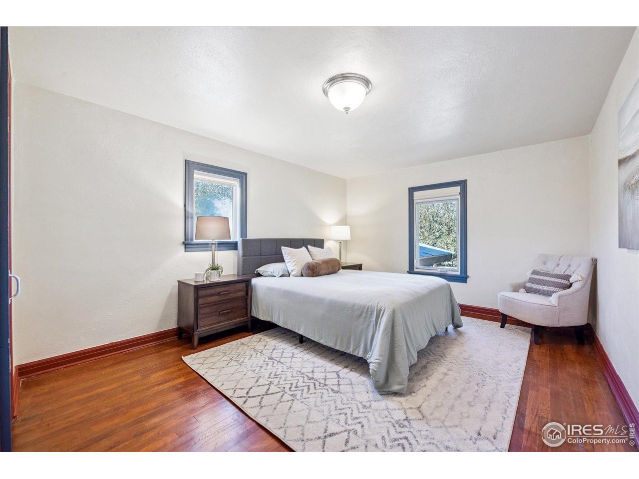1351 Marshall Road Boulder, CO 80305 - Photo 22 of 46 a bedroom with a bed and wooden floor