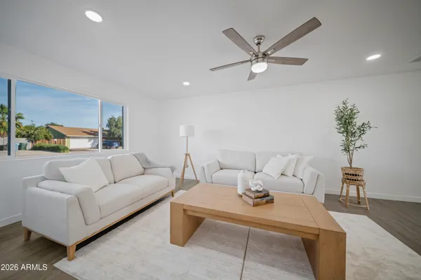 a kitchen with stainless steel appliances kitchen island a sink a refrigerator a center island and a window