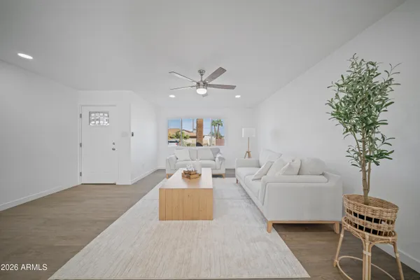 a kitchen with kitchen island a sink stainless steel appliances and white cabinets