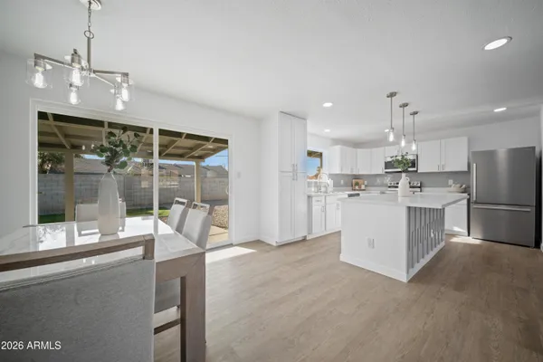 a living room with furniture and kitchen view