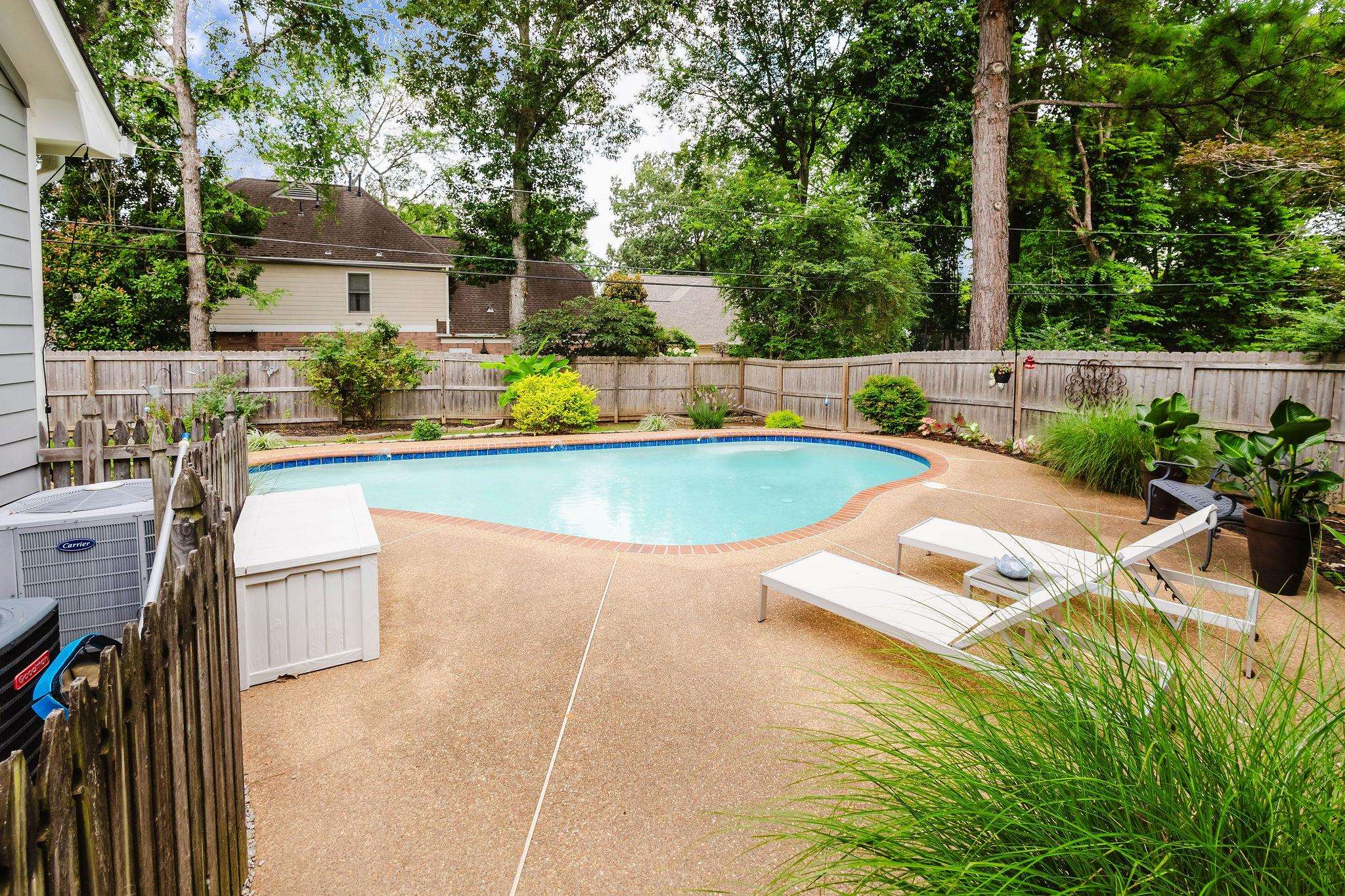 305 Great Falls Road Collierville, TN 38017 - Photo 20 of 23 Backyard oasis featuring a freeform swimming pool with a blue tile border, surrounded by a concrete patio