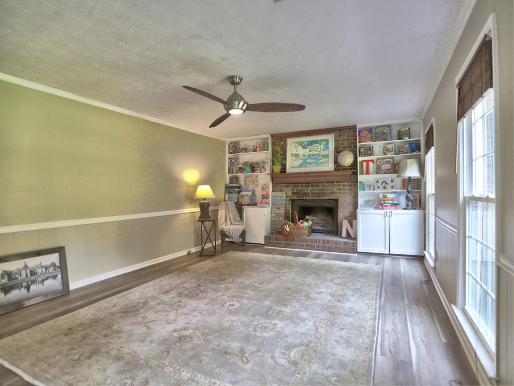 4512 Woodlawn Lake Drive Marietta, GA 30068 - Photo 15 of 55 a view of a livingroom with a fireplace a ceiling fan and window