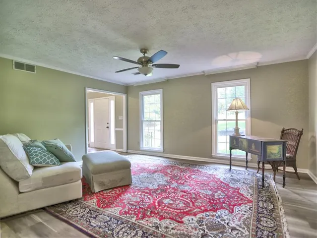 a view of a livingroom with dining area a flat screen tv