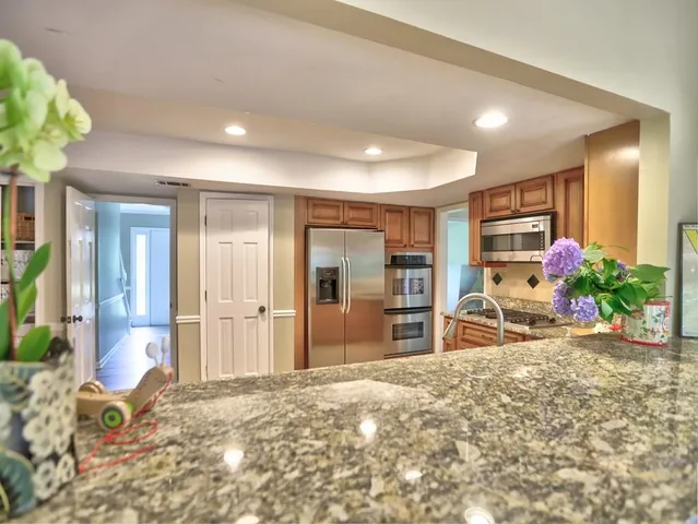 a kitchen with granite countertop a sink and cabinets