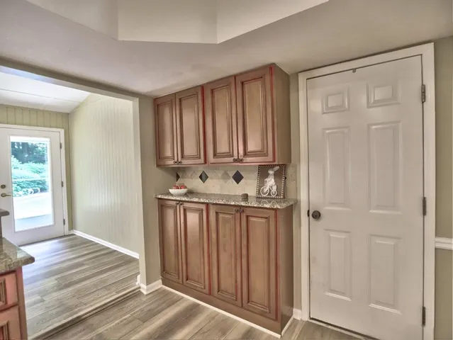 a kitchen with granite countertop a stove and cabinets