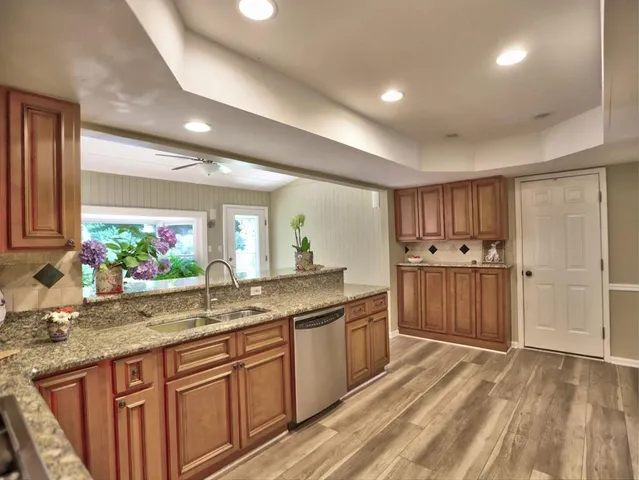 a kitchen with stainless steel appliances granite countertop a stove and a sink