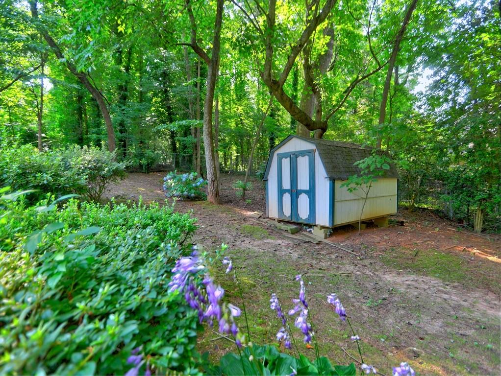 4512 Woodlawn Lake Drive Marietta, GA 30068 - Photo 25 of 55 a backyard of a house with lots of green space and fountain