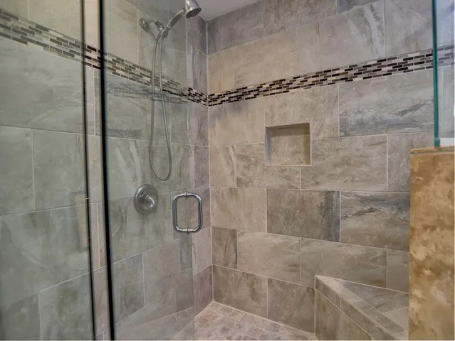 a bathroom with a granite countertop sink mirror and a bath tub