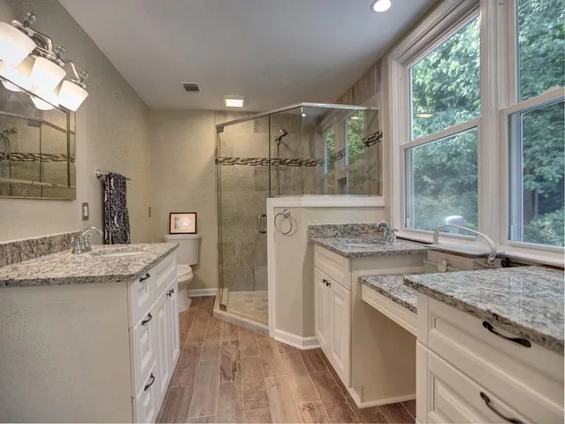 an empty room with wooden floor and window