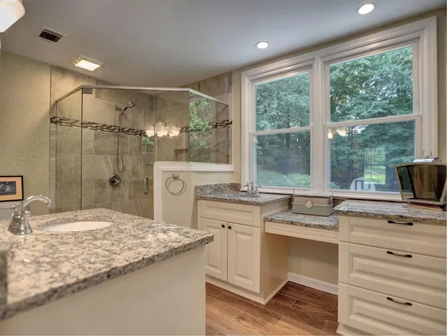 a view of a room with a hanging light and hardwood