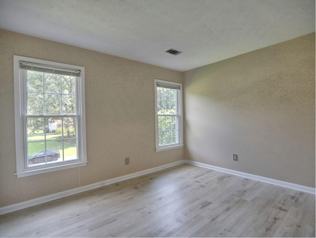 4512 Woodlawn Lake Drive Marietta, GA 30068 - Photo 33 of 55 a view of empty room with wooden floor and fan