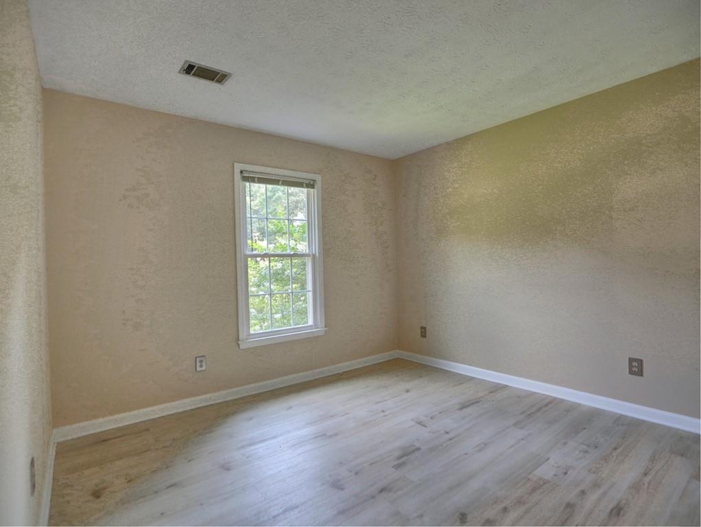 4512 Woodlawn Lake Drive Marietta, GA 30068 - Photo 34 of 55 an empty room with wooden floor and window
