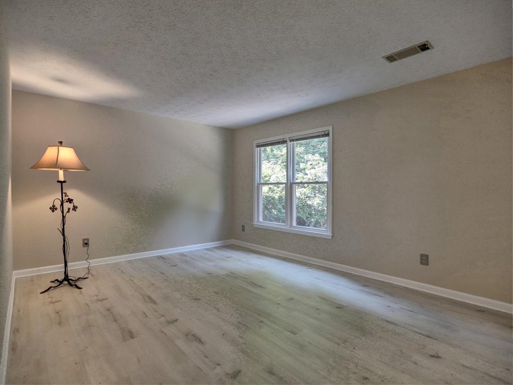 4512 Woodlawn Lake Drive Marietta, GA 30068 - Photo 35 of 55 a view of a room with a hanging light and hardwood