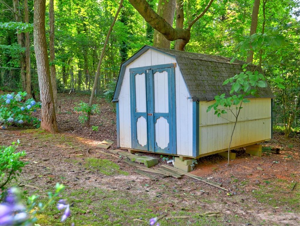 4512 Woodlawn Lake Drive Marietta, GA 30068 - Photo 40 of 55 a wooden bench sitting in front of a house