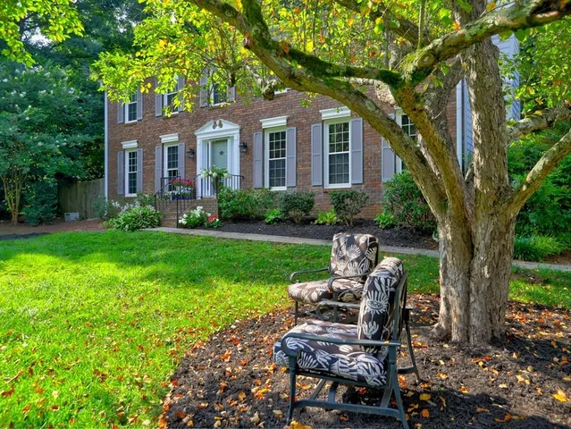 a view of a house with backyard sitting area and garden