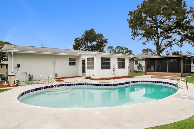 a view of a house with swimming pool and porch