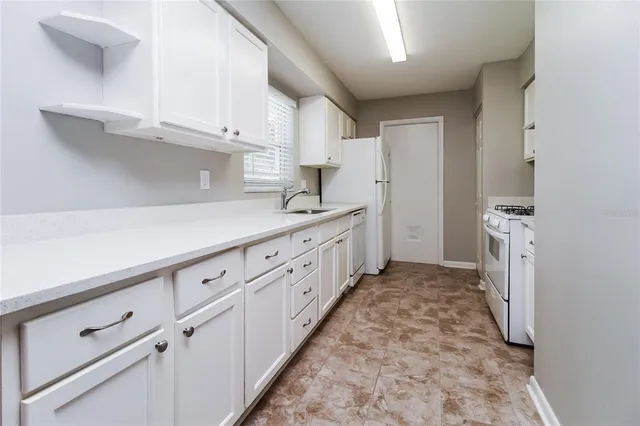 a kitchen with white cabinets