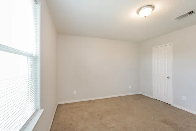 a view of an empty room and a window