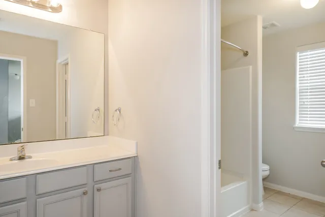 a bathroom with a shower sink and mirror