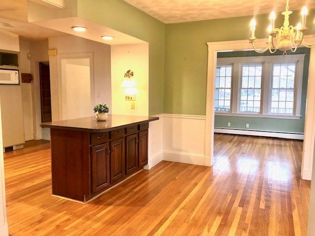10 Summer Street Saugus, MA 01906 - Photo 11 of 42 a view of a room with wooden floor and cabinets