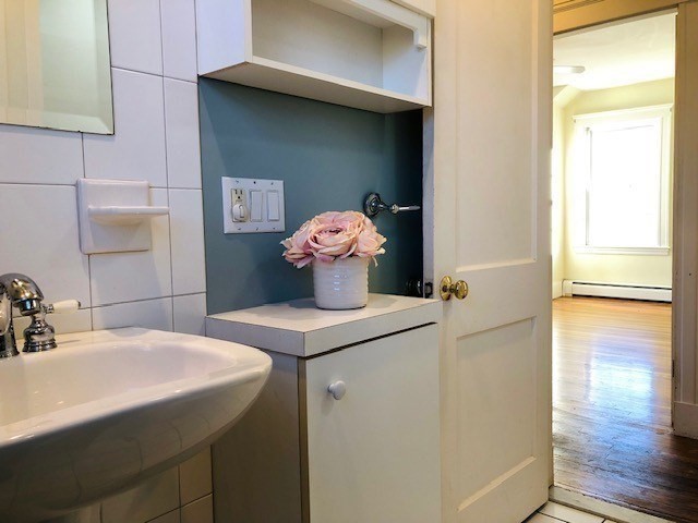 10 Summer Street Saugus, MA 01906 - Photo 24 of 42 a bathroom with a sink a toilet and mirror