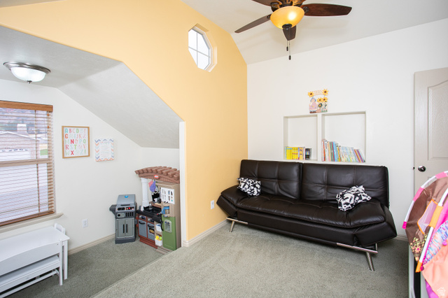 426 Deer Hollow Road Tooele, UT 84074 - Photo 16 of 37 Carpeted living area featuring plenty of natural light, vaulted ceiling, and a ceiling fan
