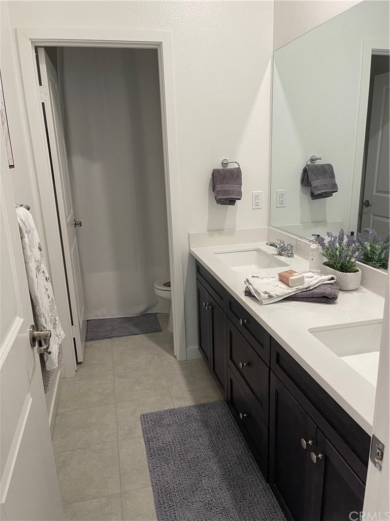40274 Vivaldi Court Indio, CA 92203 - Photo 13 of 23 a bathroom with a sink a vanity and a mirror