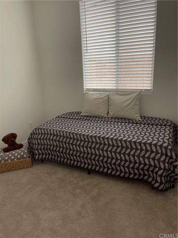 a bed sitting in a bedroom next to a window