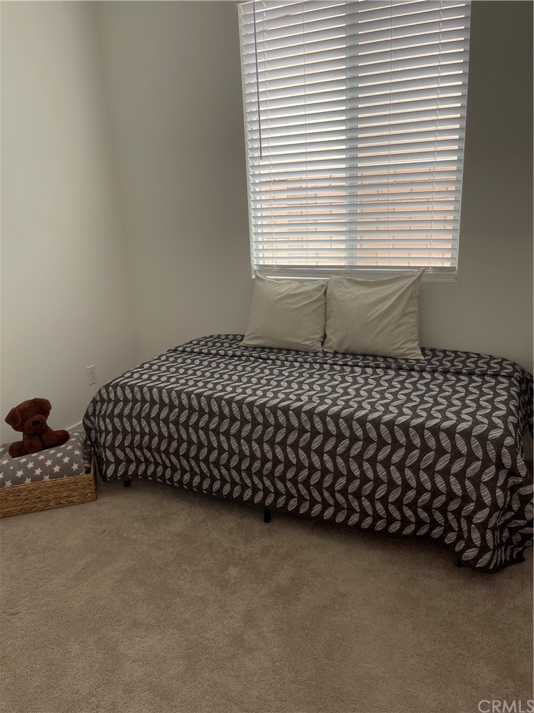 40274 Vivaldi Court Indio, CA 92203 - Photo 14 of 23 a bed sitting in a bedroom next to a window