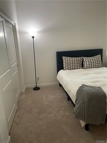 a bedroom with a bed and a mirror