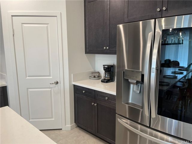 a kitchen with a refrigerator and cabinets