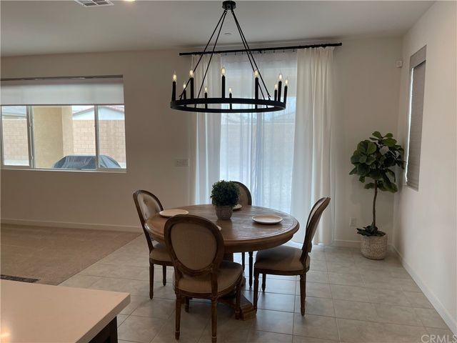 a dining room with furniture and window