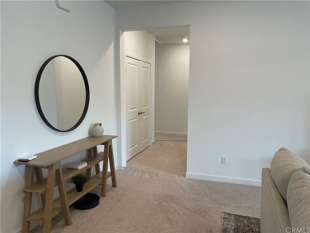 a view of a livingroom with furniture and a mirror