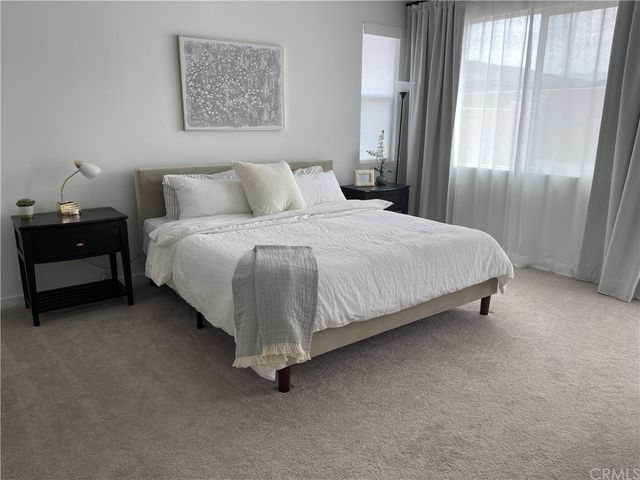 a bedroom with a bed and window