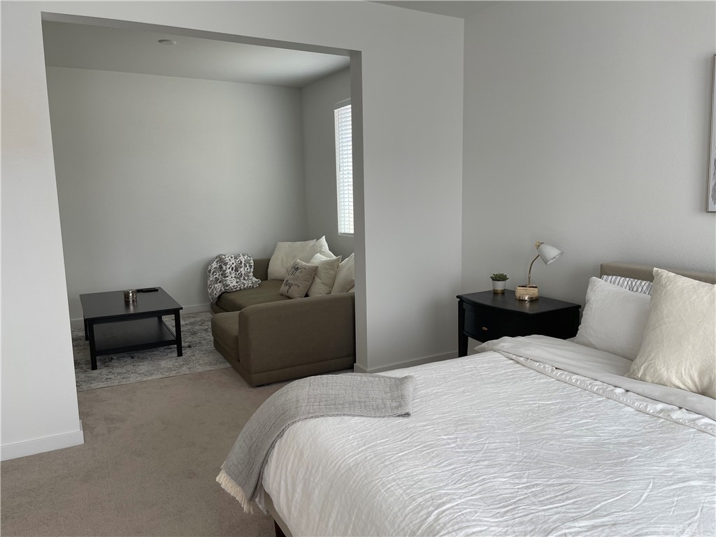 40274 Vivaldi Court Indio, CA 92203 - Photo 10 of 23 a bedroom with a bed and a couch