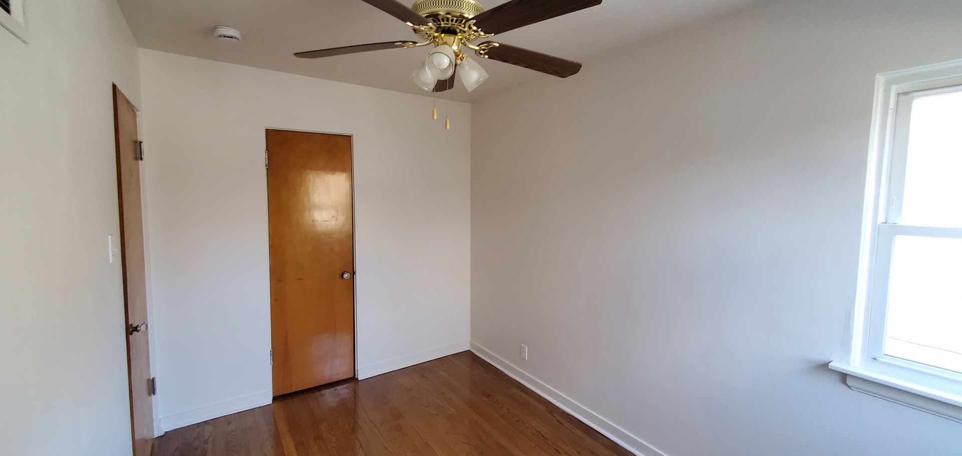 2305 South 15th Avenue Broadview, IL 60155 - Photo 5 of 6 an empty room with windows and fan
