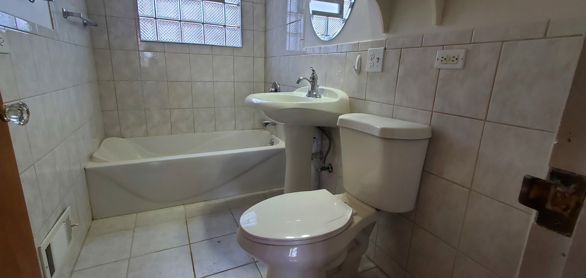 2305 South 15th Avenue Broadview, IL 60155 - Photo 6 of 6 a white toilet sitting next to a white bath tub