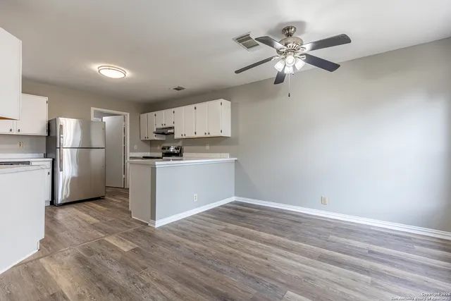 a kitchen with stainless steel appliances a refrigerator and a stove top oven