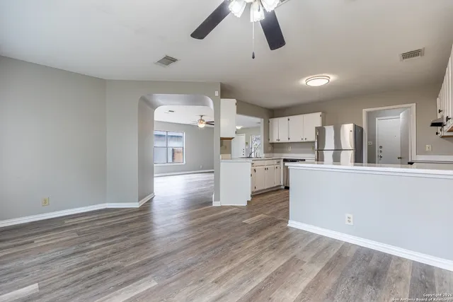 a view of a kitchen with wooden floor