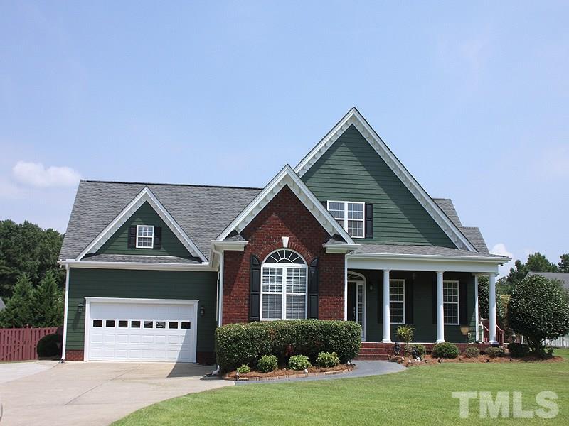1036 Newburgh Circle Raleigh, NC 27603 - Photo 2 of 25 a front view of a house with a yard and garage