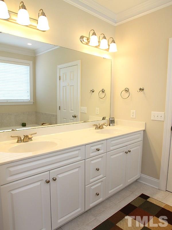 1036 Newburgh Circle Raleigh, NC 27603 - Photo 11 of 25 a bathroom with a granite countertop sink mirror and