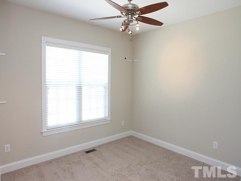 1036 Newburgh Circle Raleigh, NC 27603 - Photo 13 of 25 an empty room with a window and a fan