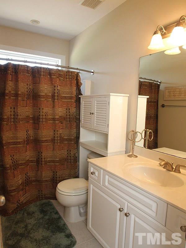 1036 Newburgh Circle Raleigh, NC 27603 - Photo 15 of 25 a bathroom with a sink a toilet and shower