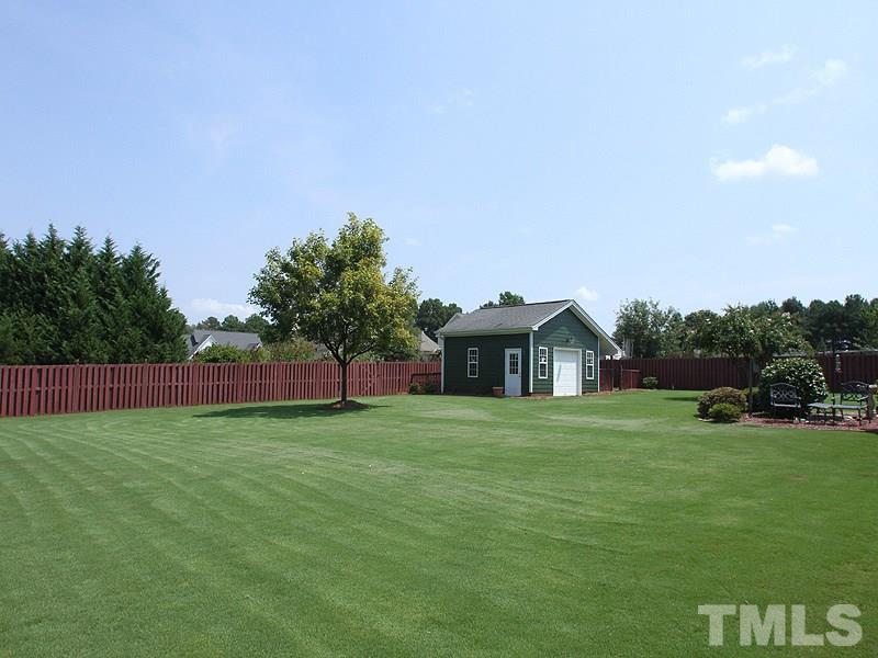 1036 Newburgh Circle Raleigh, NC 27603 - Photo 23 of 25 a big house with a big yard and large trees