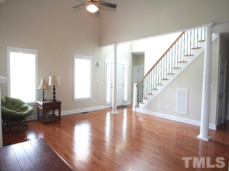 1036 Newburgh Circle Raleigh, NC 27603 - Photo 4 of 25 a view of a livingroom with furniture stairs wooden floor and windows